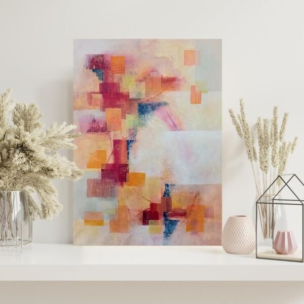 Red and orange abstract wall art on a white shelf, styled with neutral vases and dried floral decor.